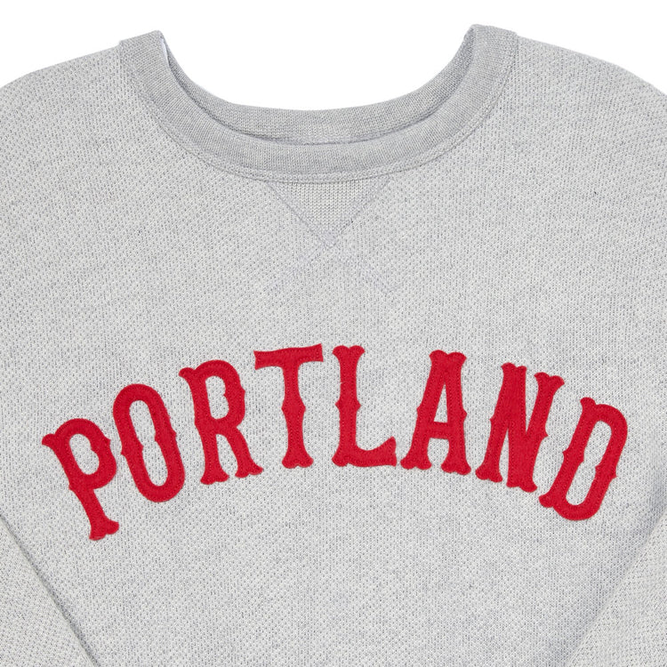 The EFF Portland Beavers Crewneck Sweatshirt features a vintage-cut gray French terry fabric, with PORTLAND boldly printed in red across the chest.