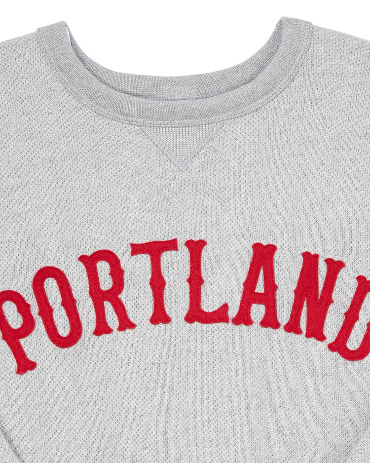 The EFF Portland Beavers Crewneck Sweatshirt features a vintage-cut gray French terry fabric, with PORTLAND boldly printed in red across the chest.