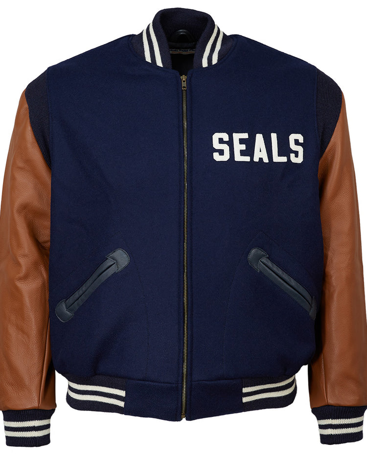 The EFF San Francisco Seals 1949 Authentic Jacket features navy blue wool, brown leather sleeves, black pockets, white stripes on the collar, cuffs and waistband, and “SEALS” in white on the left chest.