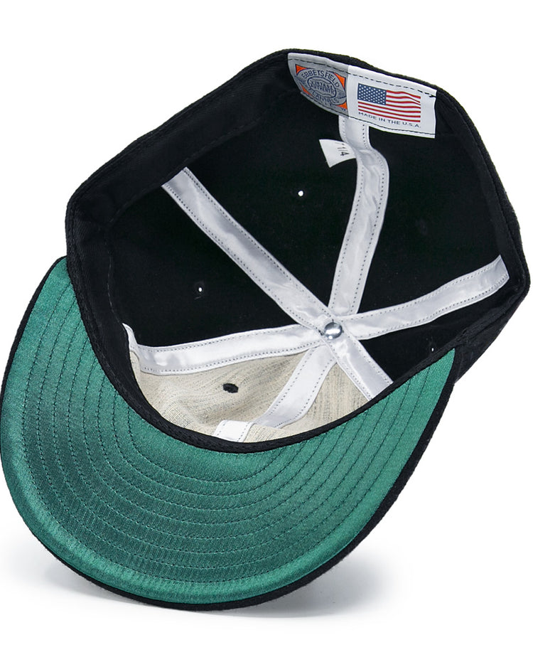 The inside view of the EFF San Francisco Seals Vintage Inspired Ballcap features a green underbrim, white sweatband, and an American flag tag sewn into the seam.