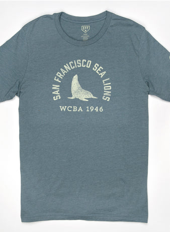 The EFF San Francisco Sea Lions 1946 T-Shirt is a unisex premium cotton heathered tee in blue, featuring white San Francisco Sea Lions WCBA 1946 text and a central sea lion graphic, inspired by the West Coast Baseball Association.
