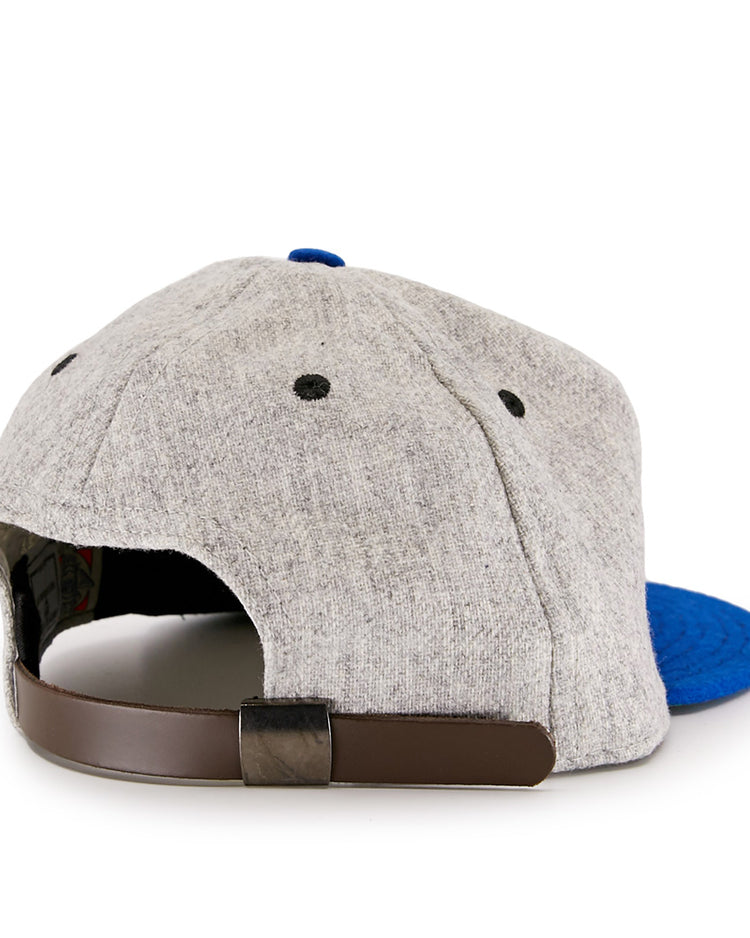 The EFF St. Louis Stars 1929 Vintage Ballcap features a gray crown, blue brim, black eyelets, and a brown adjustable strap with a black buckle, shown from the back and inspired by classic Negro National League style.