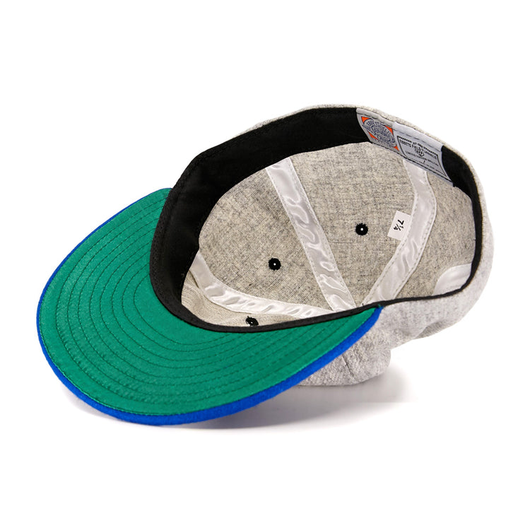 The EFF St. Louis Stars 1929 Vintage Ballcap, inspired by the Negro National League era, features a green and blue brim, black inner band, white stitched lining, and a size tag marked 7 1/4.