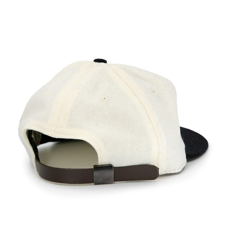 The Tokyo Kyojin (Giants) 1948 Vintage Ballcap by Ebbets Field Flannels is pictured from the back, showing its cream color, black adjustable strap, and black brim against a white background.