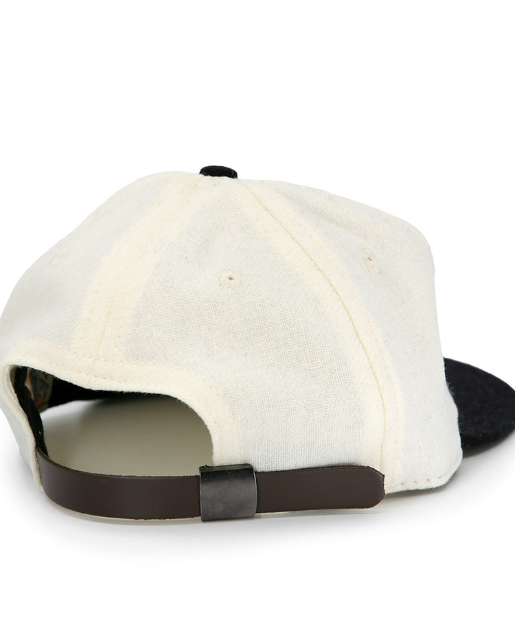 The Tokyo Kyojin (Giants) 1948 Vintage Ballcap by Ebbets Field Flannels is pictured from the back, showing its cream color, black adjustable strap, and black brim against a white background.