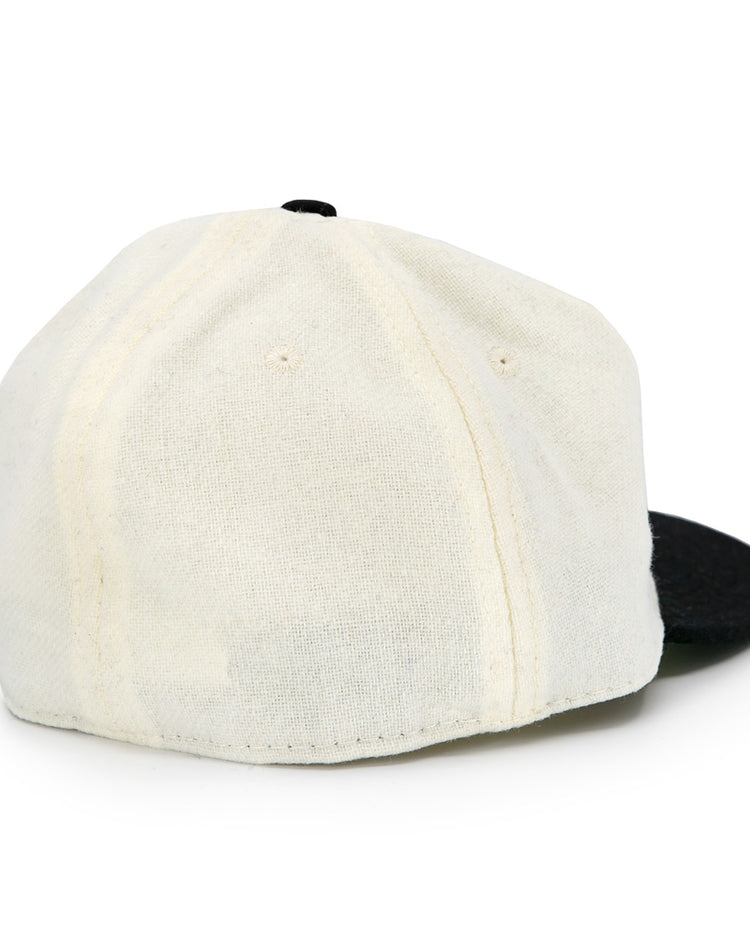 The Tokyo Kyojin (Giants) 1948 Vintage Ballcap by Ebbets Field Flannels features an off-white crown, black brim, visible stitching, and an authentic wool design without logos or an adjustable strap. Shown from the back.