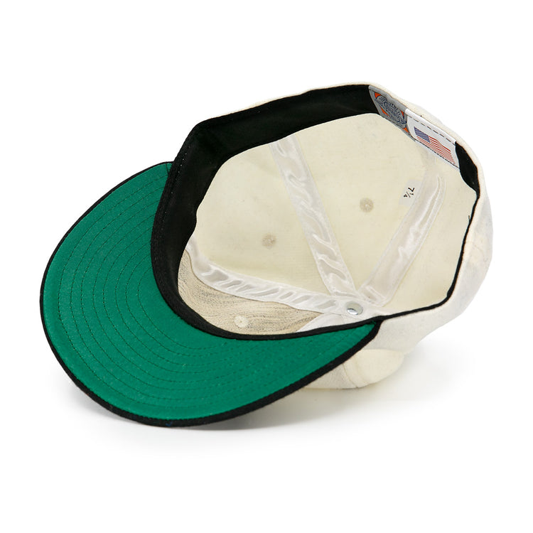 The Tokyo Kyojin (Giants) 1948 Vintage Ballcap by Ebbets Field Flannels is shown upside down, revealing a green brim underside, black inner band, white panels, and an inside American flag tag.
