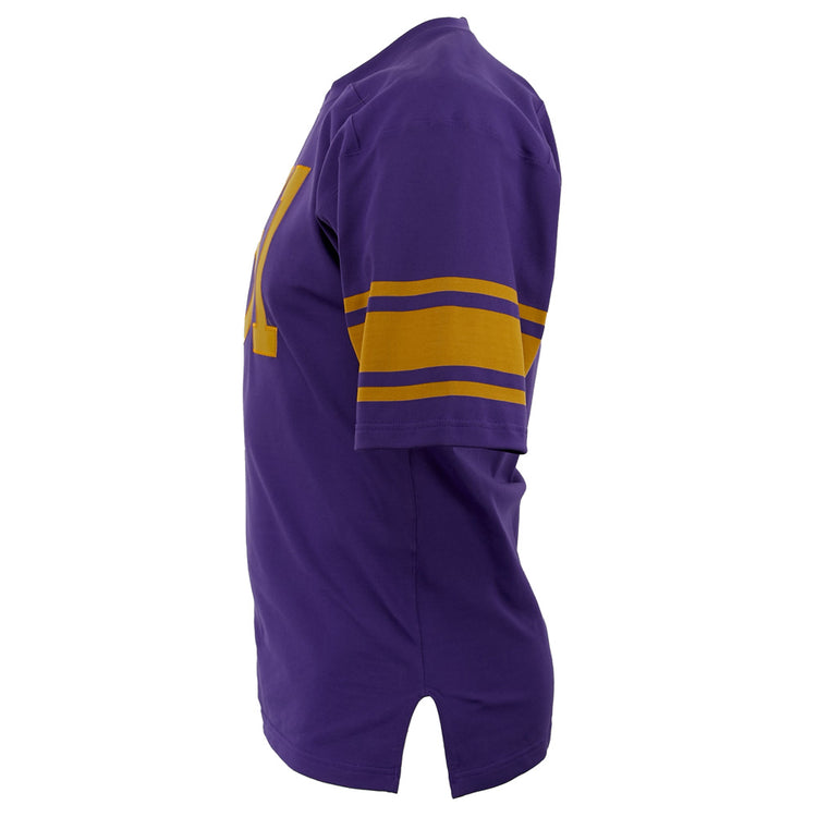 The EFF University of Washington 1970 Durene Football Jersey is a purple short-sleeve shirt with gold sleeve stripes and a gold letter on the front, shown from the side against a white background.