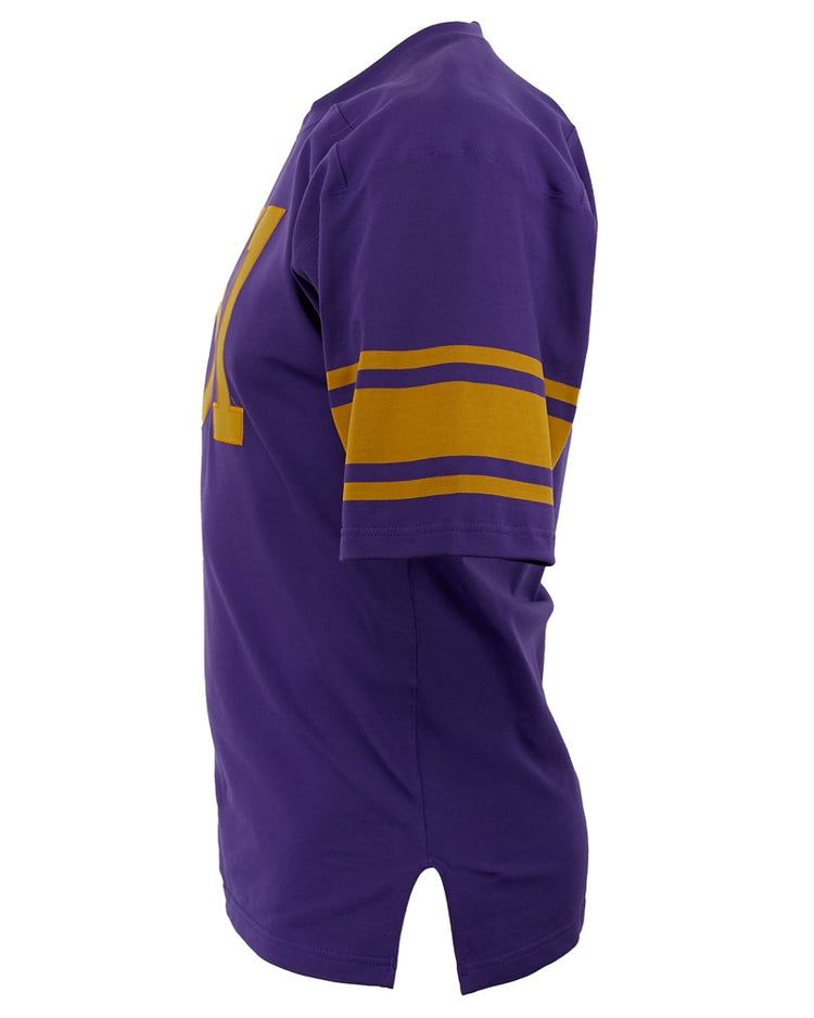 The EFF University of Washington 1970 Durene Football Jersey is a purple short-sleeve shirt with gold sleeve stripes and a gold letter on the front, shown from the side against a white background.