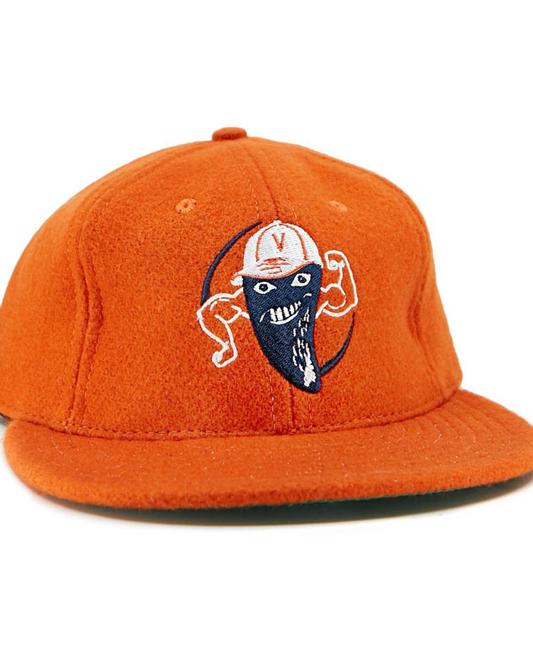 The EFF Victoria Mussels 1979 Vintage Ballcap is an orange cap with an embroidered smiling character—blue face mask, flexed arms, and a white cap featuring a red V on the front.