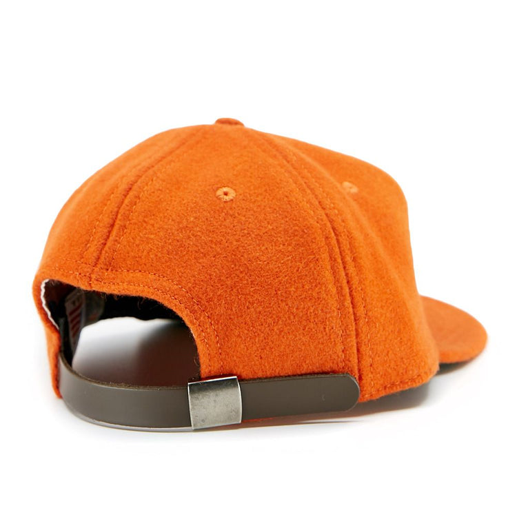The EFF Victoria Mussels 1979 Vintage Ballcap is shown from the back, featuring orange genuine wool and a brown adjustable strap with a silver buckle for a classic look.