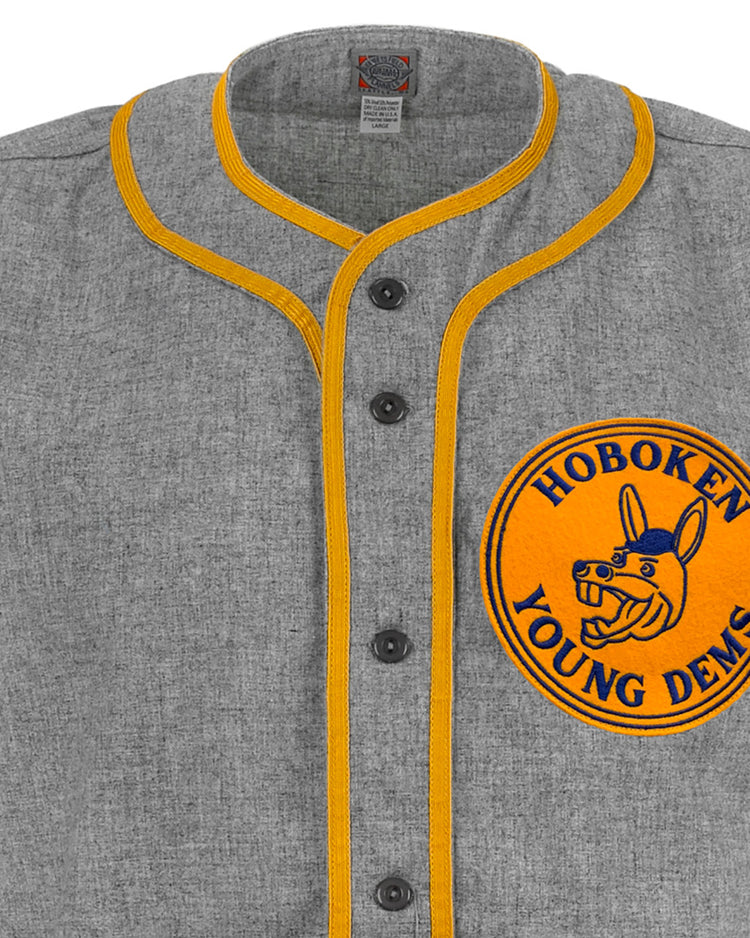 The EFF Hoboken Young Democrats 1972 Road Jersey is a gray vintage baseball jersey with yellow trim, black buttons, and a large yellow chest patch featuring Hoboken Young Dems and a blue donkey—ideal for Little League history fans.