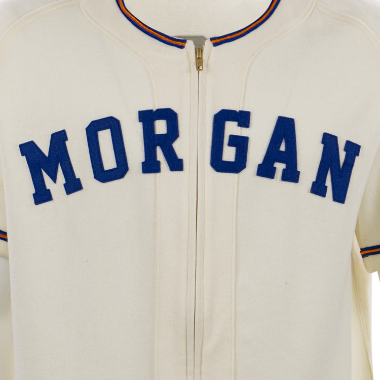 The EFF Morgan State University 1975 Home Jersey features a cream color, MORGAN in bold blue letters on the chest, and red-and-blue trim on the collar and sleeves—an authentic reproduction of the classic jersey.