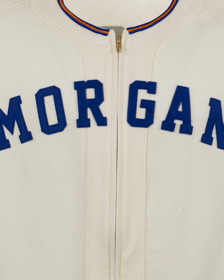 The EFF Morgan State University 1975 Home Jersey features a cream color, MORGAN in bold blue letters on the chest, and red-and-blue trim on the collar and sleeves—an authentic reproduction of the classic jersey.