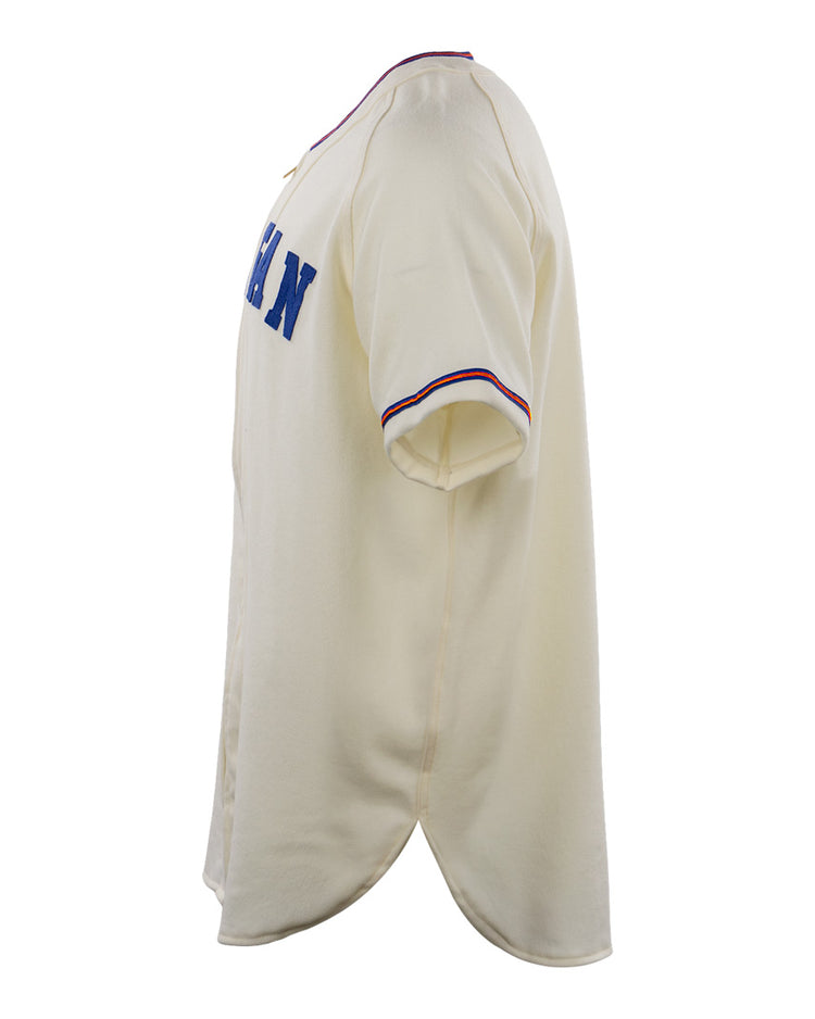 The EFF Morgan State University 1975 Home Jersey is a cream short-sleeve authentic reproduction featuring blue chest lettering and red-blue striped sleeve cuffs, inspired by the original 1975 design.