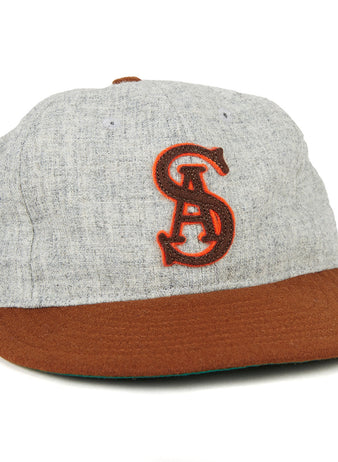 The EFF San Antonio Missions 1938 Vintage Ballcap features a gray crown, brown brim, and an authentic red embroidered intertwined SA logo, echoing the classic teams original style.