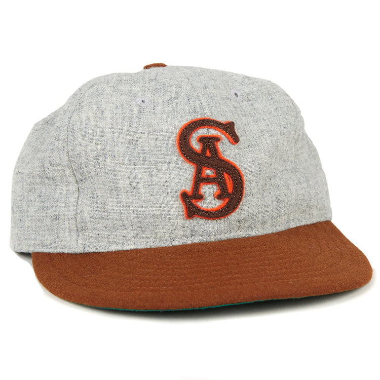 The EFF San Antonio Missions 1938 Vintage Ballcap features a gray crown, brown brim, and an authentic red embroidered intertwined SA logo, echoing the classic teams original style.